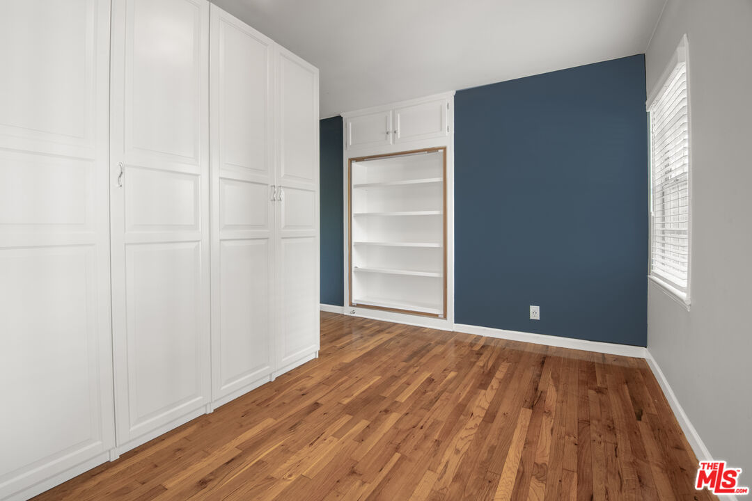 6218 Balcom Avenue Encino, CA 91316 - Photo 14 of 22 a view of an empty room with closet and wooden floor