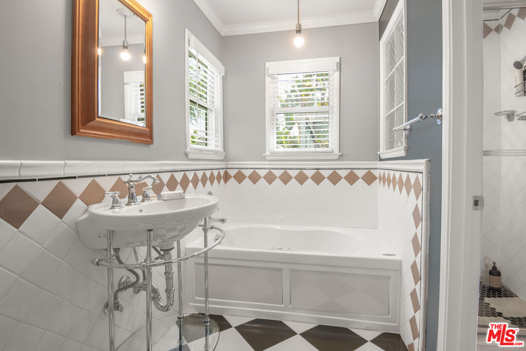 6218 Balcom Avenue Encino, CA 91316 - Photo 15 of 22 a bathroom with a bathtub and a shower