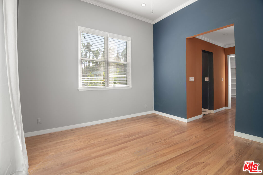6218 Balcom Avenue Encino, CA 91316 - Photo 17 of 22 an empty room with wooden floor and windows