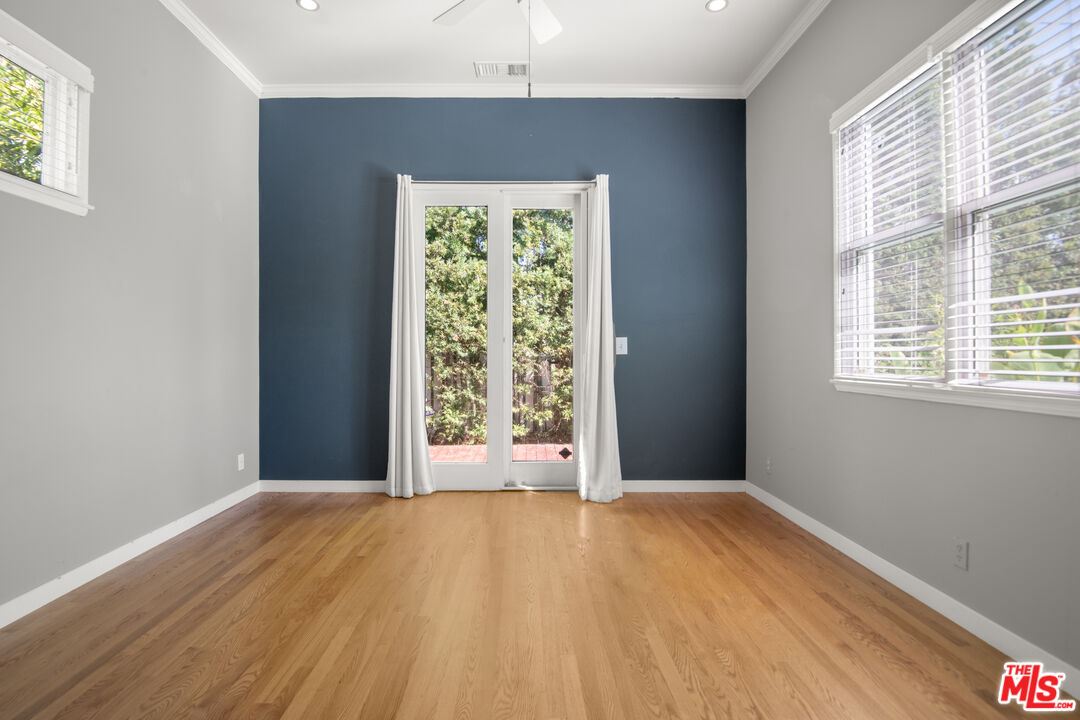 6218 Balcom Avenue Encino, CA 91316 - Photo 18 of 22 an empty room with wooden floor and windows