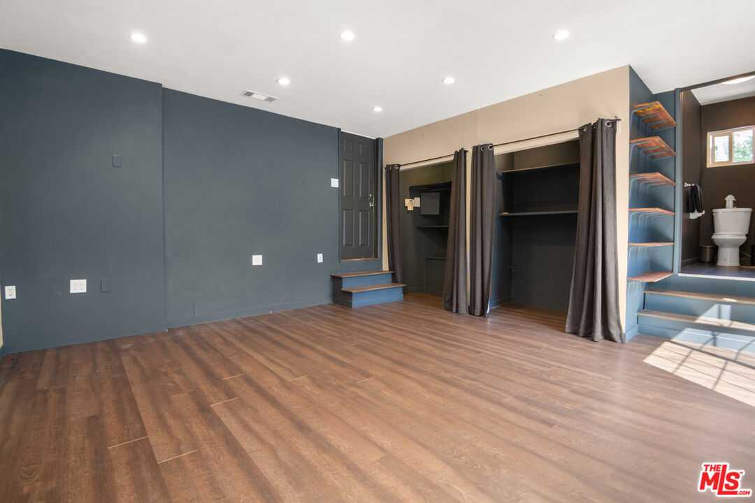 6218 Balcom Avenue Encino, CA 91316 - Photo 19 of 22 a view of an empty room with wooden floor