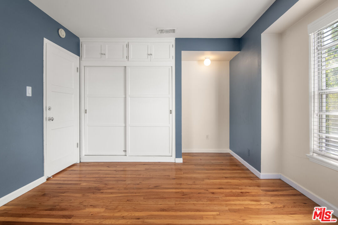 6218 Balcom Avenue Encino, CA 91316 - Photo 9 of 22 a view of an empty room with wooden floor and a window