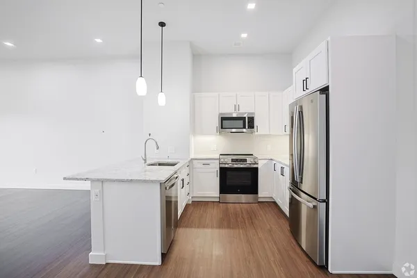 a kitchen with stainless steel appliances a refrigerator sink and stove