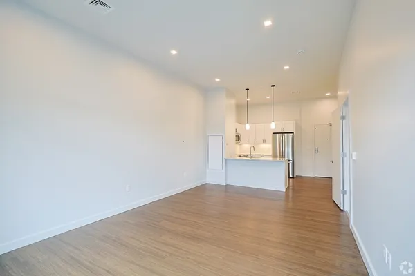 a view of a kitchen with a refrigerator and a sink