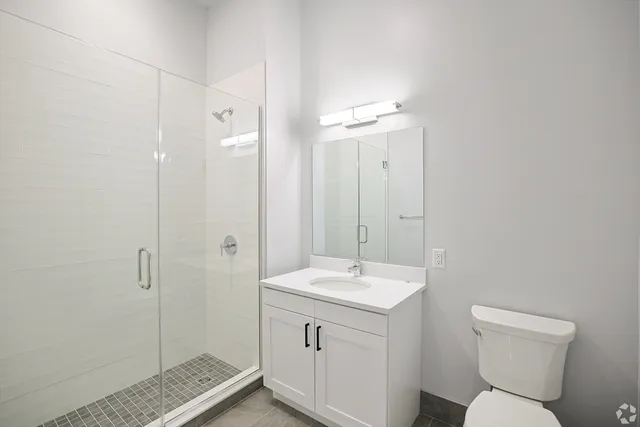a bathroom with a toilet sink and shower