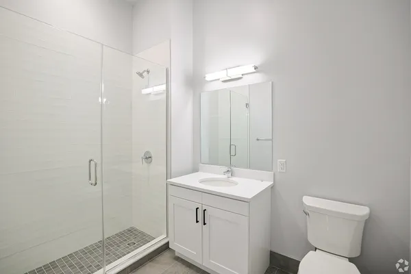 a bathroom with a toilet sink and shower