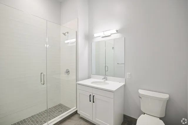 a bathroom with a toilet sink and shower