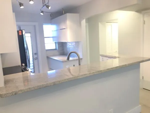 a view of a sink and a window in a room