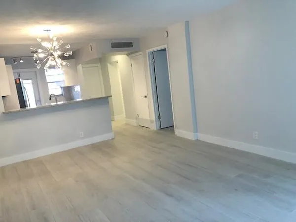a view of a hallway with chandelier