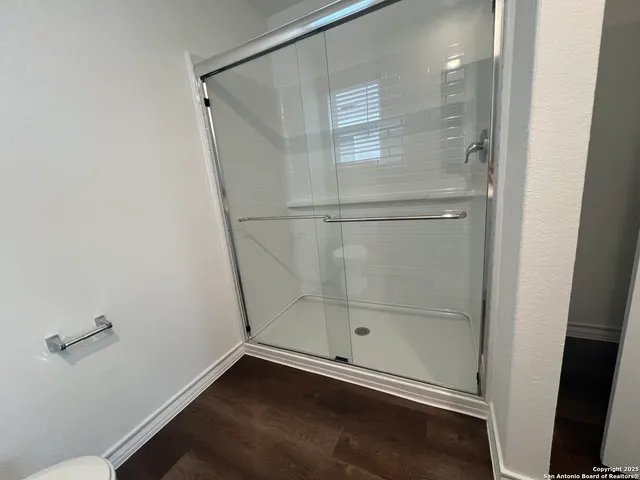 a bathroom with a glass shower door