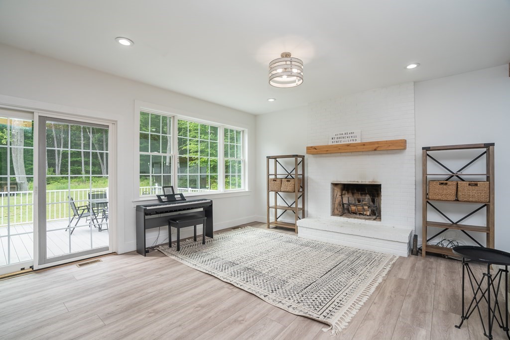 77 Jourdan Road Montgomery, MA 01085 - Photo 17 of 42 a living room with furniture and a fireplace