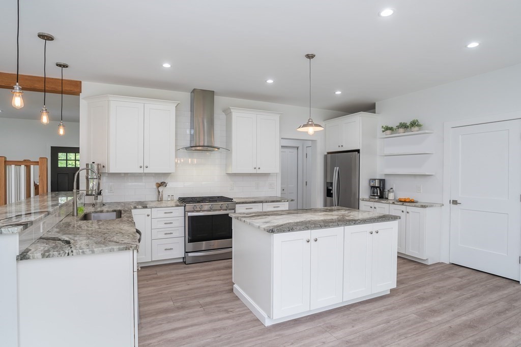 77 Jourdan Road Montgomery, MA 01085 - Photo 23 of 42 a kitchen with a sink stove and cabinets