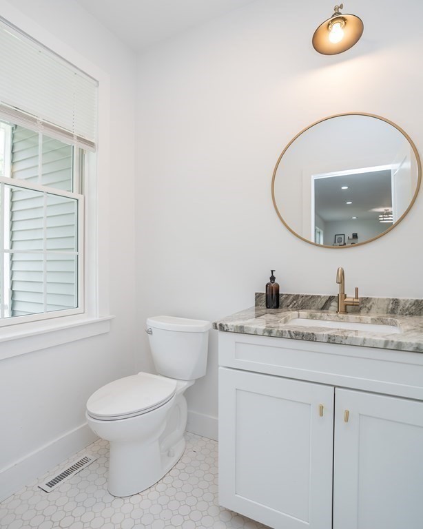 77 Jourdan Road Montgomery, MA 01085 - Photo 26 of 42 a bathroom with a granite countertop toilet sink mirror and vanity