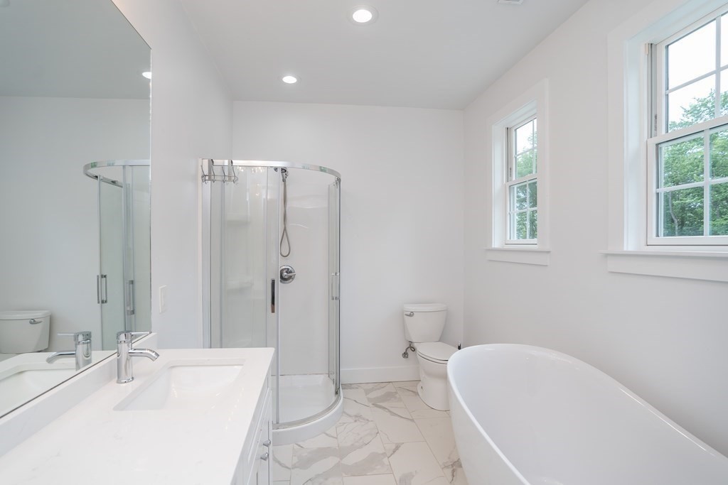 77 Jourdan Road Montgomery, MA 01085 - Photo 31 of 42 a spacious bathroom with a tub sink and mirror