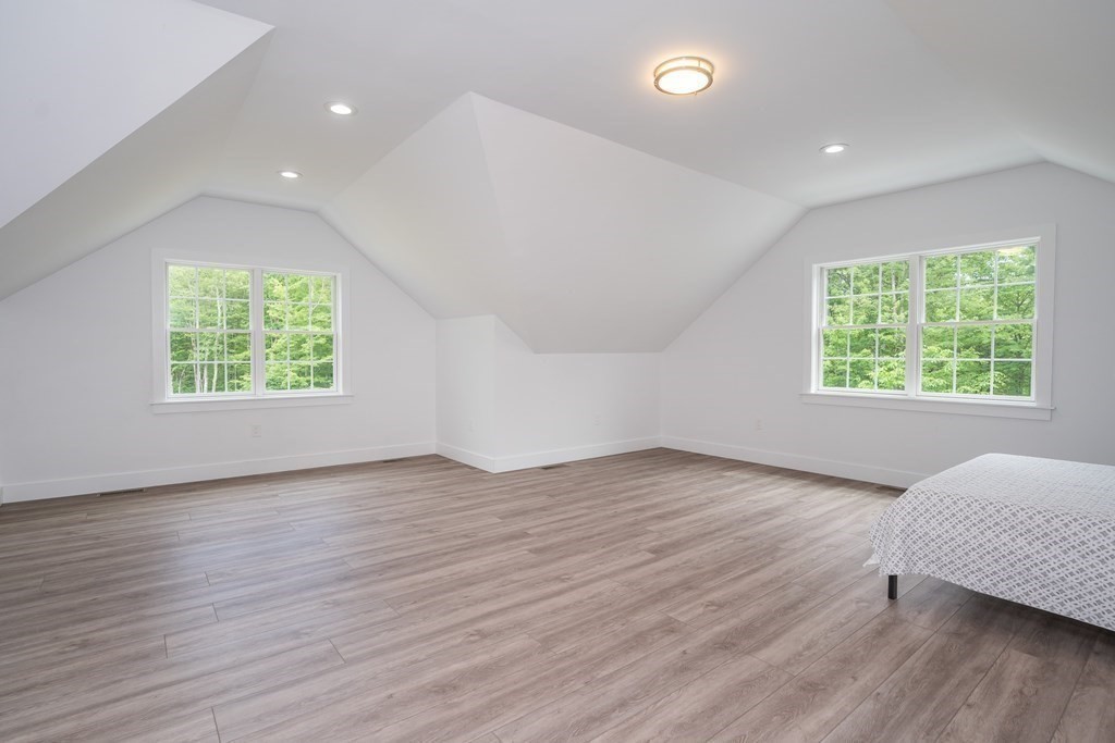 77 Jourdan Road Montgomery, MA 01085 - Photo 33 of 42 an empty room with wooden floor and windows