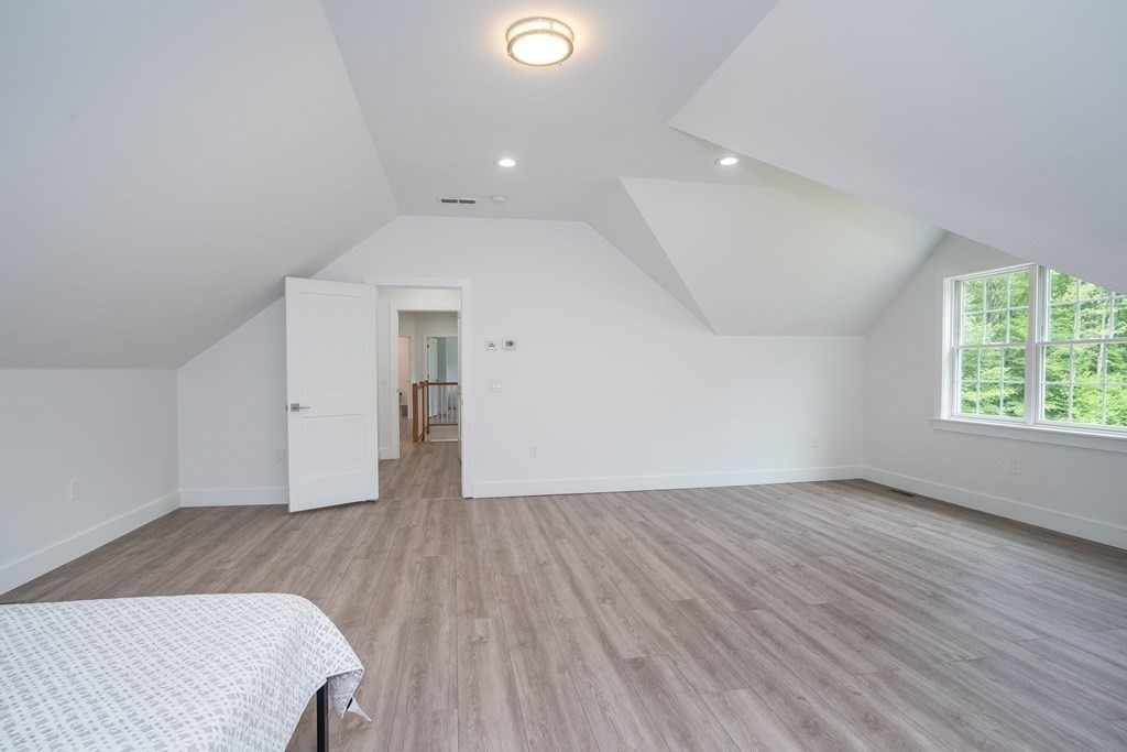 77 Jourdan Road Montgomery, MA 01085 - Photo 34 of 42 an empty room with wooden floor and windows