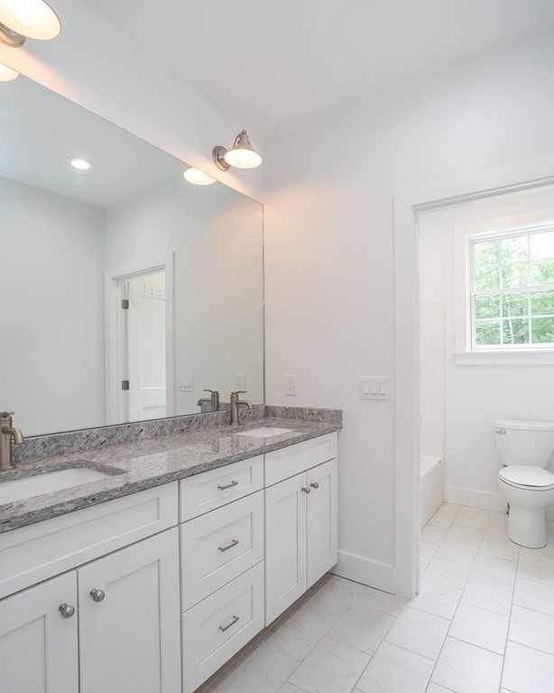 77 Jourdan Road Montgomery, MA 01085 - Photo 36 of 42 a bathroom with a granite countertop sink and a mirror