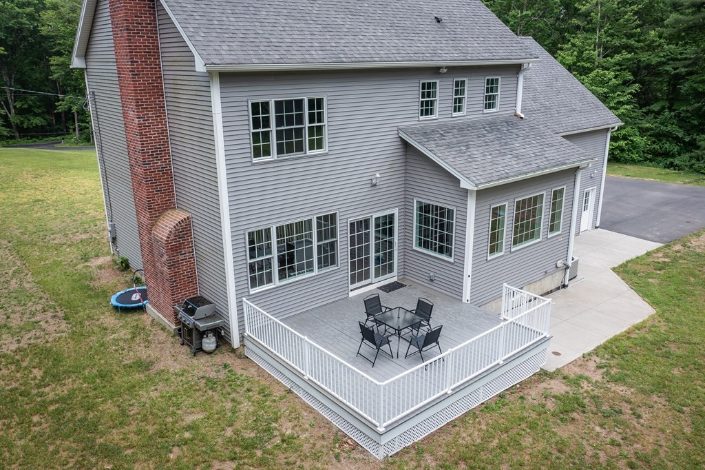 77 Jourdan Road Montgomery, MA 01085 - Photo 4 of 42 a front view of house with yard outdoor seating and barbeque oven