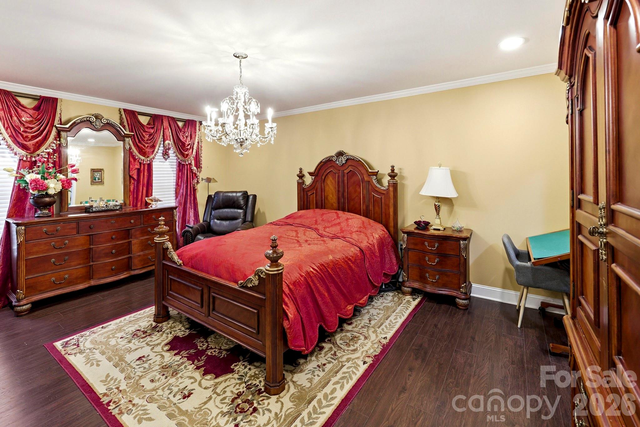 327 Sherry Street Rutherfordton, NC 28139 - Photo 11 of 22 a spacious bedroom with a bed a dresser and painting on the wall
