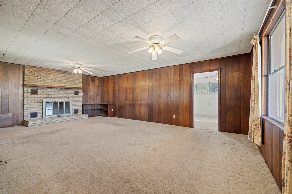 315 Rieger Road Harper, TX 78631 - Photo 11 of 31 an empty room with chandelier fan and windows