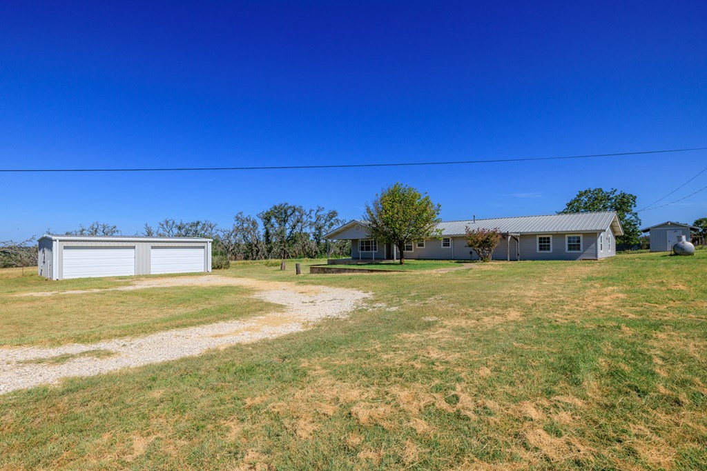 315 Rieger Road Harper, TX 78631 - Photo 17 of 31 a front view of a house with garden