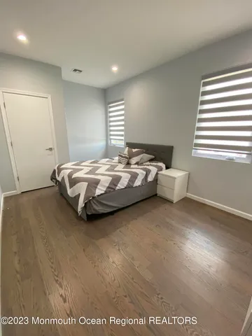 a spacious bedroom with a bed and window