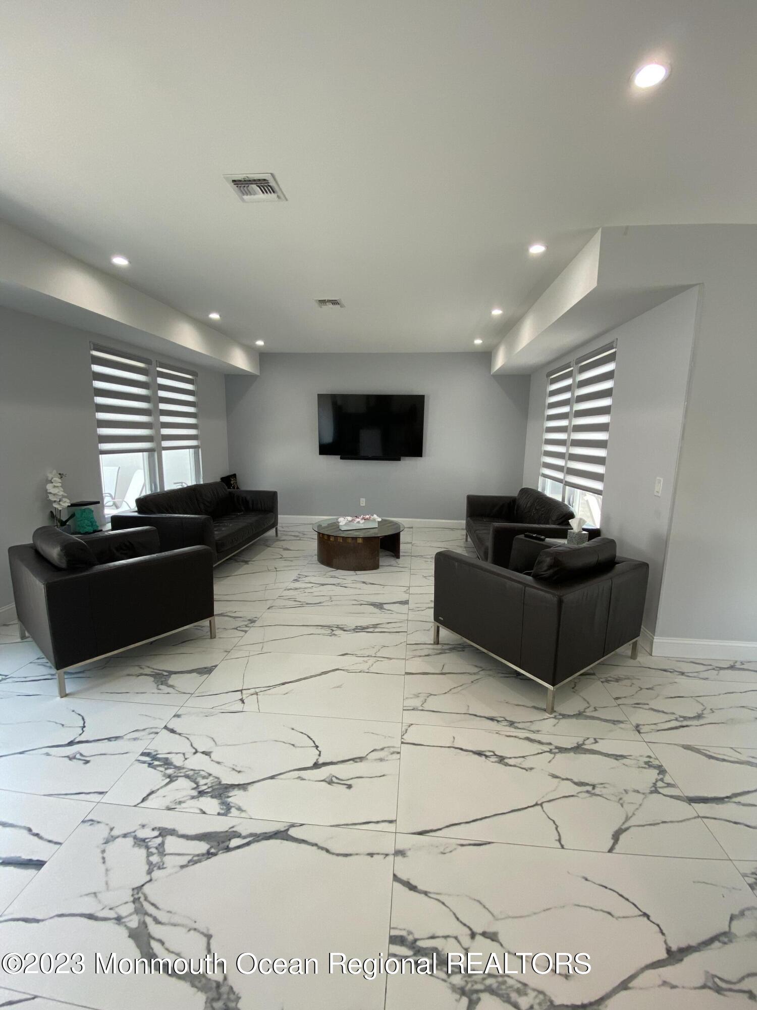 975 Van Ct Avenue Long Branch, NJ 07740 - Photo 3 of 16 a living room with furniture and a flat screen tv