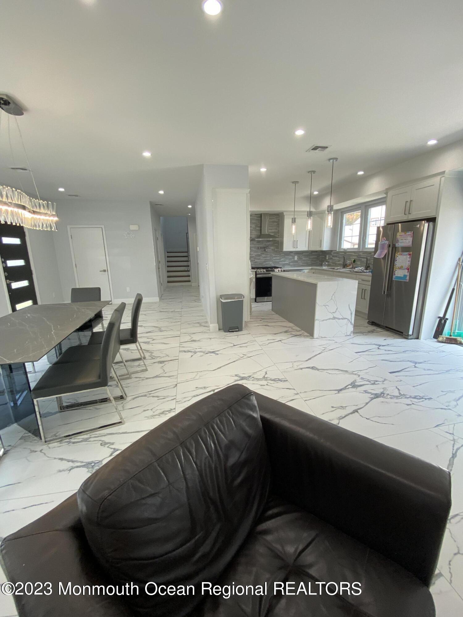 975 Van Ct Avenue Long Branch, NJ 07740 - Photo 5 of 16 a kitchen with stainless steel appliances kitchen island granite countertop a sink and white cabinets