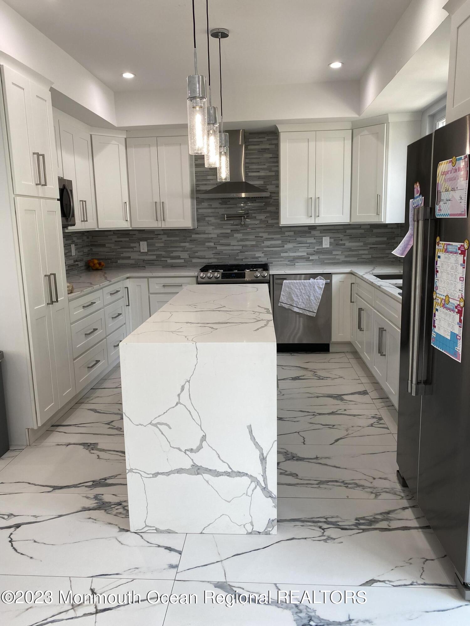 975 Van Ct Avenue Long Branch, NJ 07740 - Photo 7 of 16 a large kitchen with granite countertop a stove a sink and a refrigerator