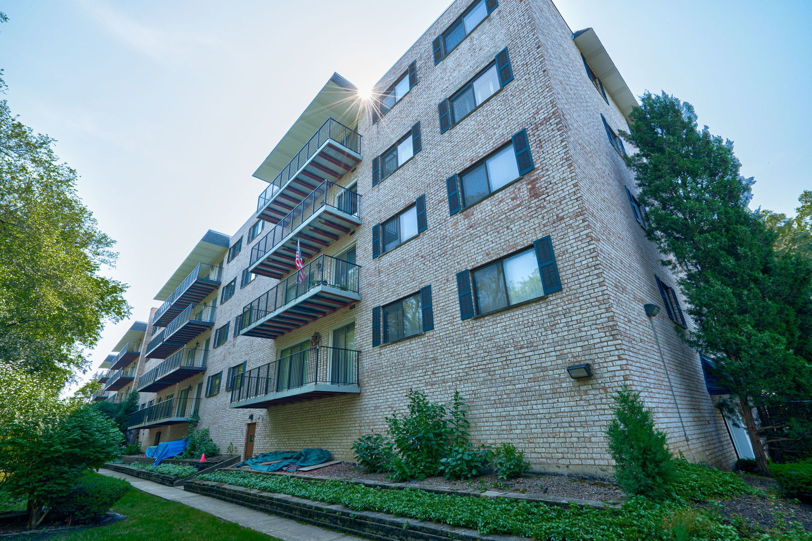 a view of a brick building next to a yard