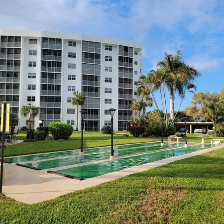 a view of a swimming pool and chairs