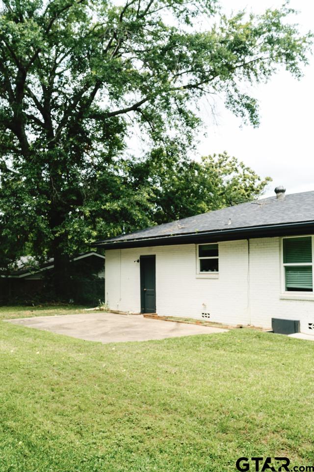 2411 Rodge Drive Tyler, TX 75701 - Photo 34 of 42 a backyard of a house with lots of green space