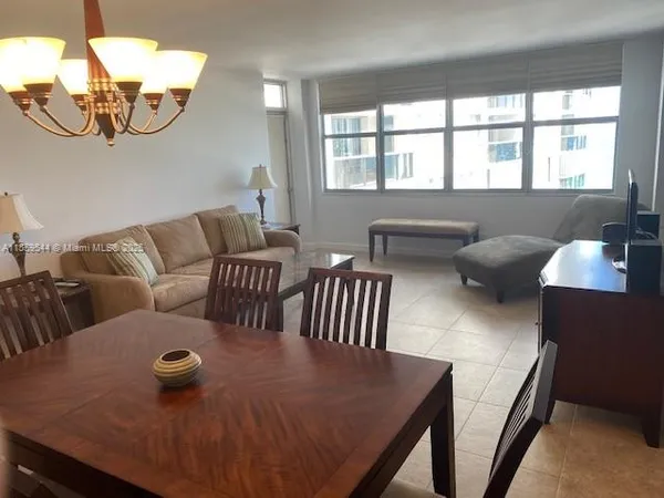 a view of a livingroom with furniture and a window