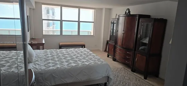 a bedroom with a bed closet and a window