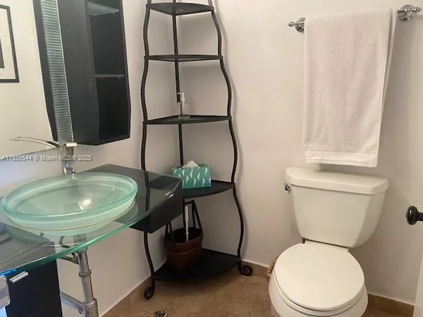 a bathroom with a toilet a sink and a mirror