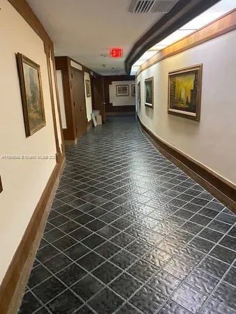 a hallway with wooden floor and windows