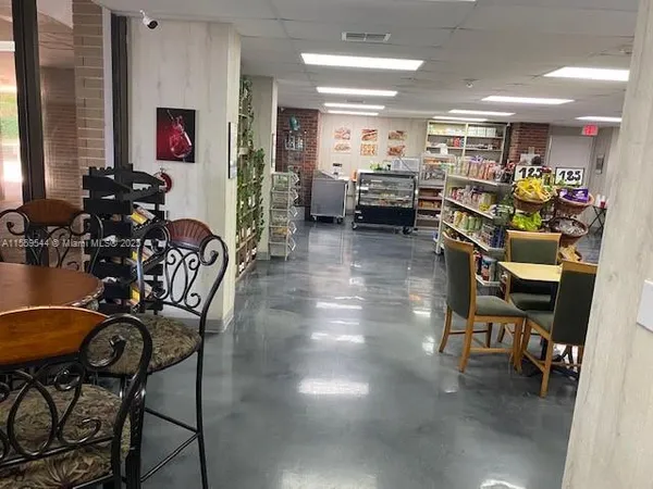 a room with lots of chairs and mirrors