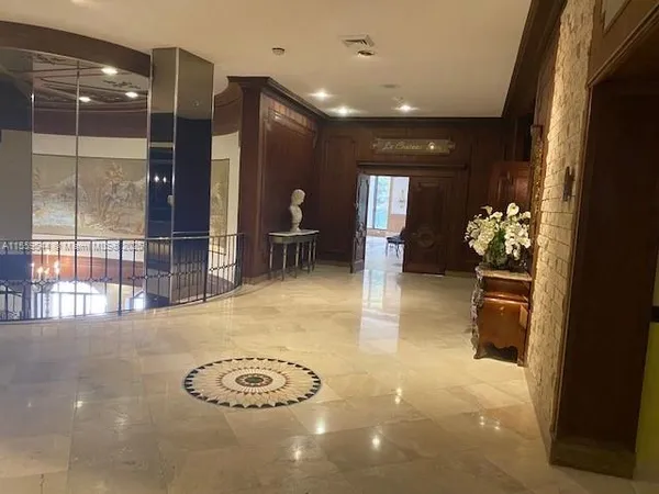 a lobby with furniture and floor to ceiling window