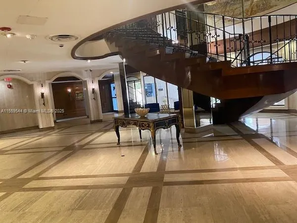a view of a lobby with furniture and a chandelier