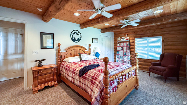 143 East Chestnut Street Helper, UT 84526 - Photo 10 of 35 Carpeted bedroom featuring rustic walls, a closet, ceiling fan, recessed lighting, and a wooden ceiling with exposed beams