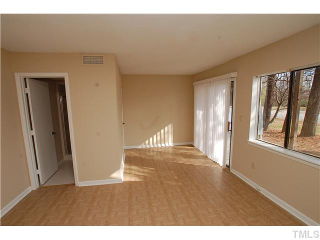 5925 Farm Gate Road Raleigh, NC 27606 - Photo 8 of 12 close view of an empty room with wooden floor and a window