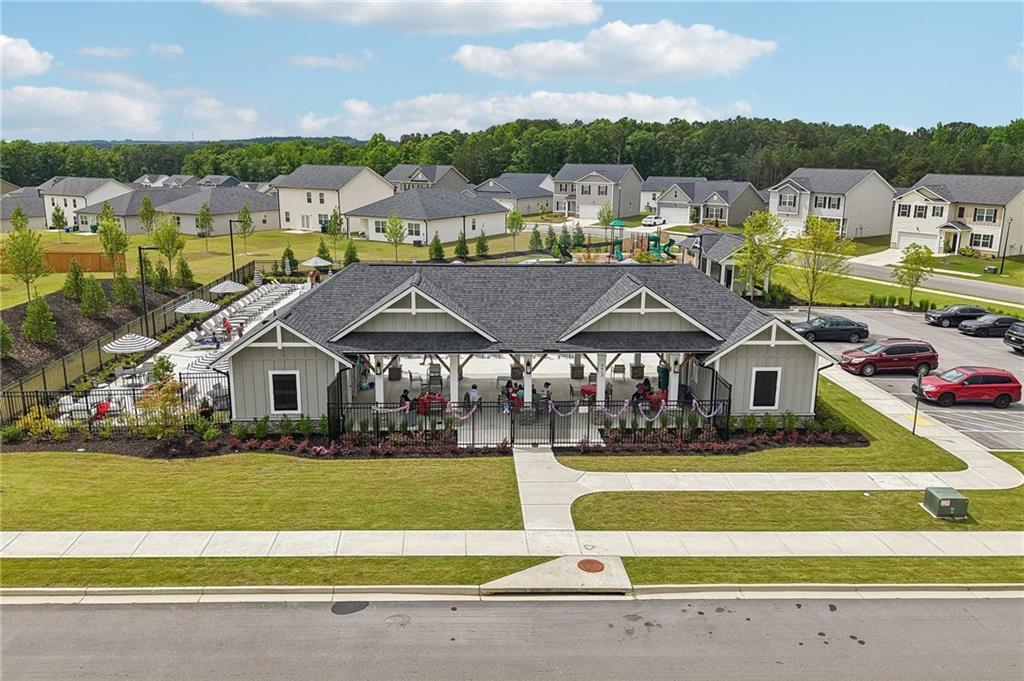 8592 Seabiscuit Road Lithonia, GA 30058 - Photo 23 of 25 a view of a big house with a big yard and large trees