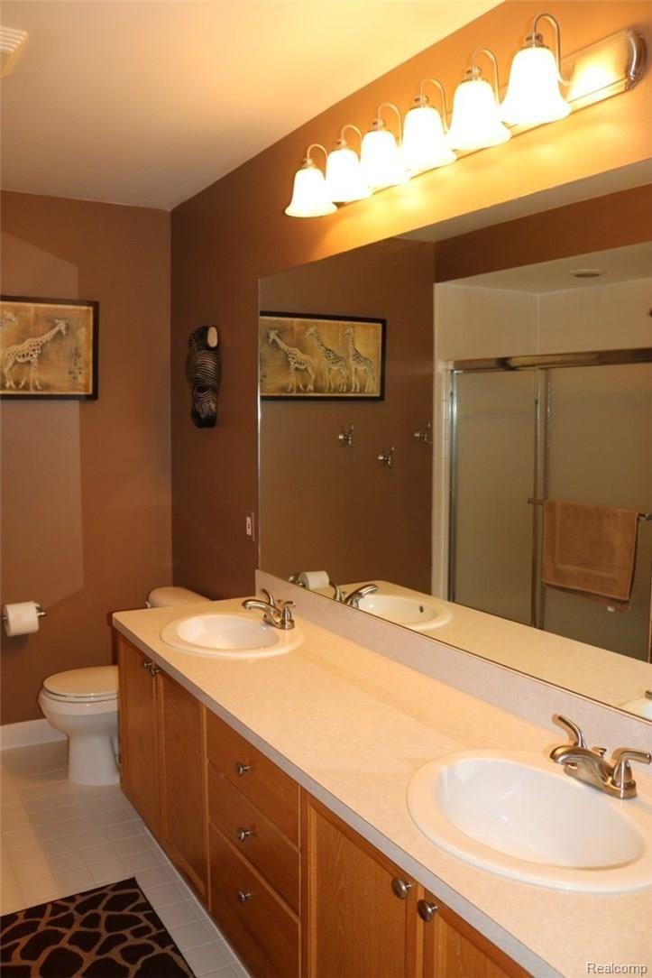1983 Blue Grass Court Rochester, MI 48306 - Photo 33 of 46 THE LARGE 3RD FULL BATHROOM (7 X 12) ON THE 2ND FLOOR CONTAINS A DOUBLE SINKS, TILED FLOOR AND TILED TUB AREA