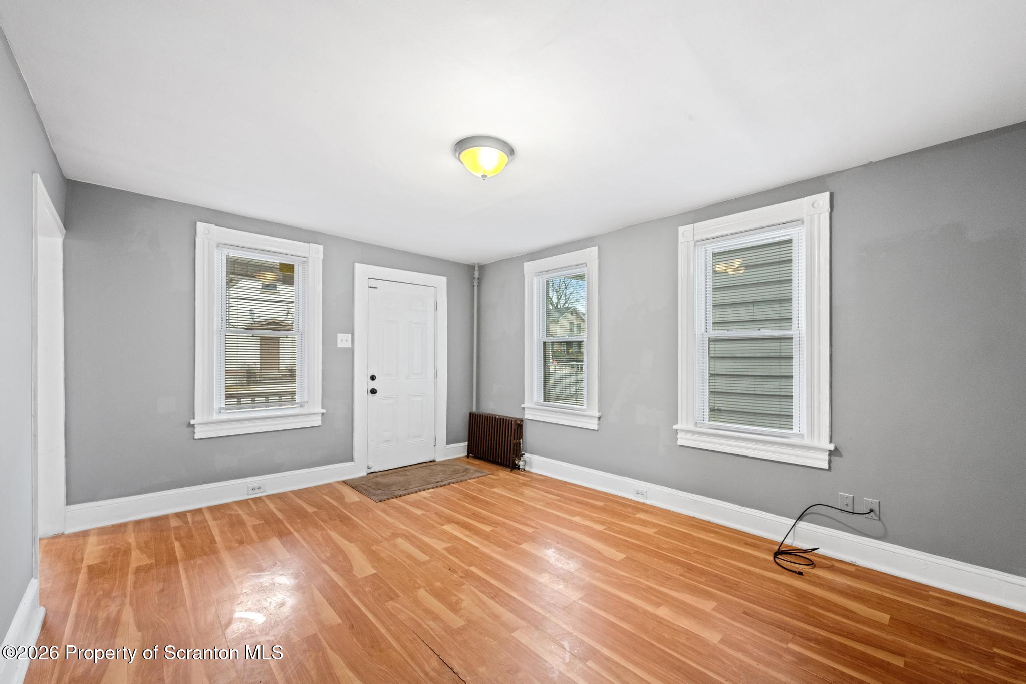 2717 North Main Avenue Scranton, PA 18508 - Photo 13 of 36 a view of an empty room with a window and wooden floor