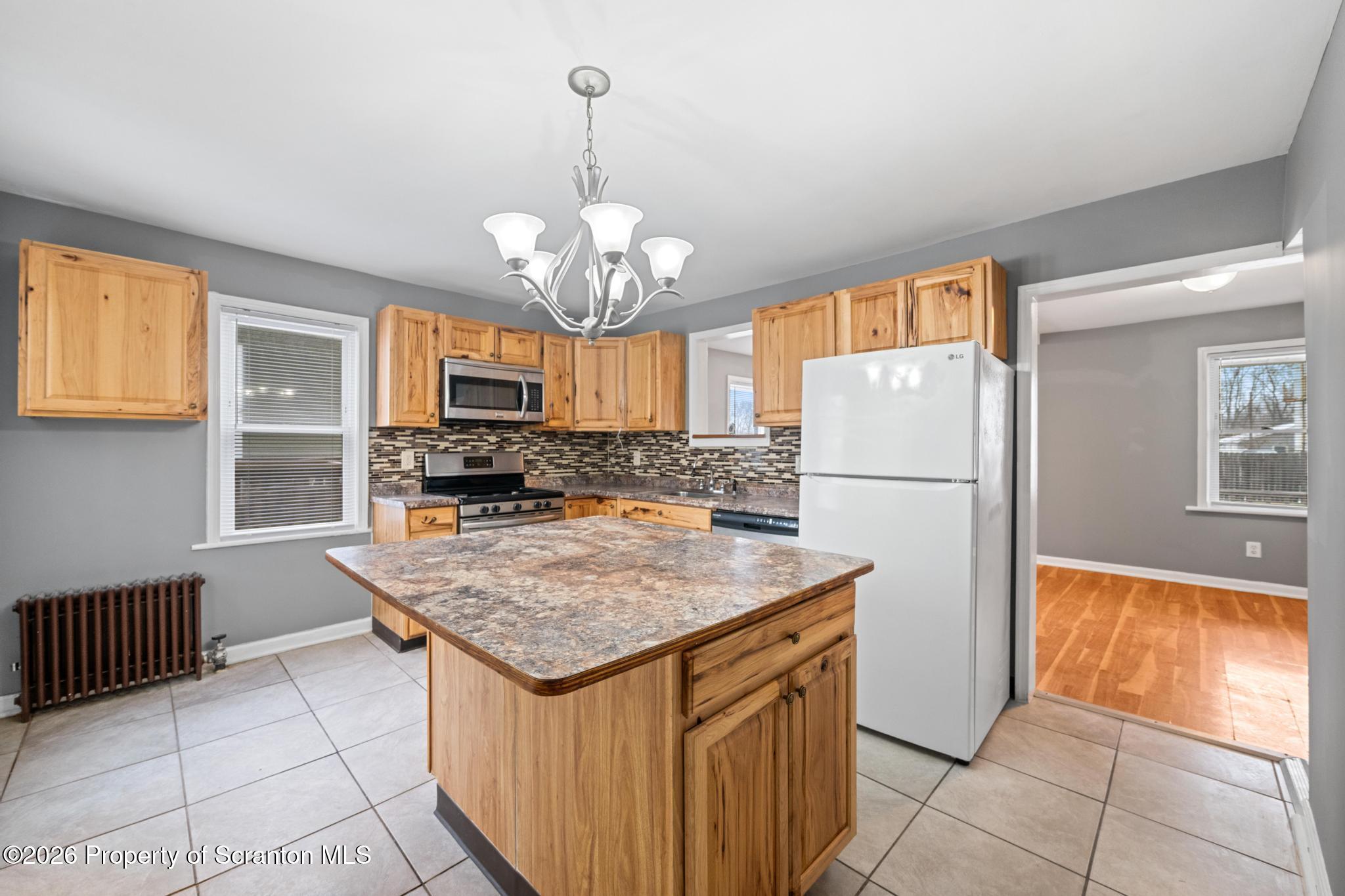 2717 North Main Avenue Scranton, PA 18508 - Photo 14 of 36 a kitchen with stainless steel appliances granite countertop a refrigerator a sink dishwasher and a wooden cabinets