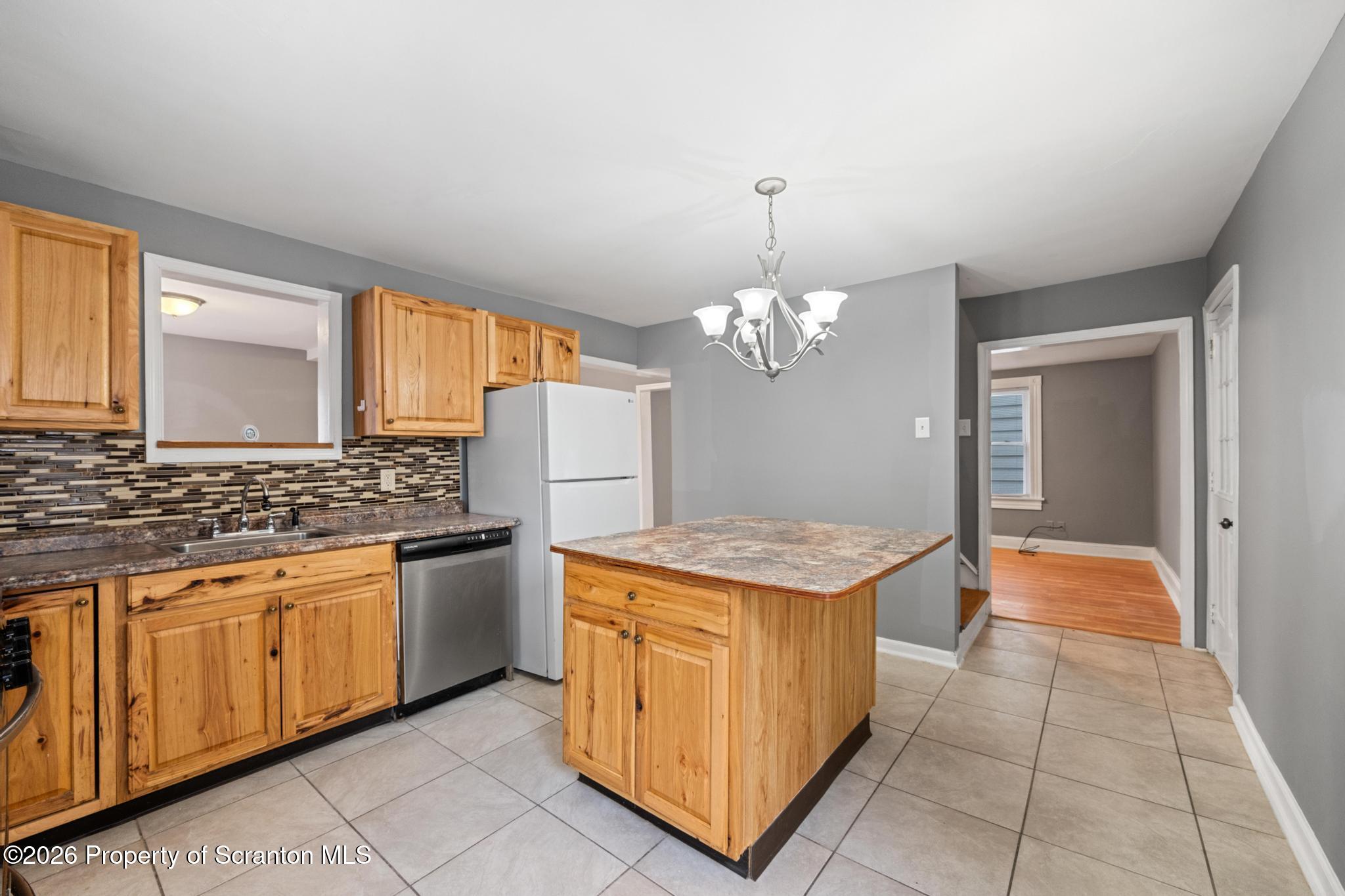 2717 North Main Avenue Scranton, PA 18508 - Photo 15 of 36 a kitchen with stainless steel appliances granite countertop a stove a sink dishwasher and a refrigerator