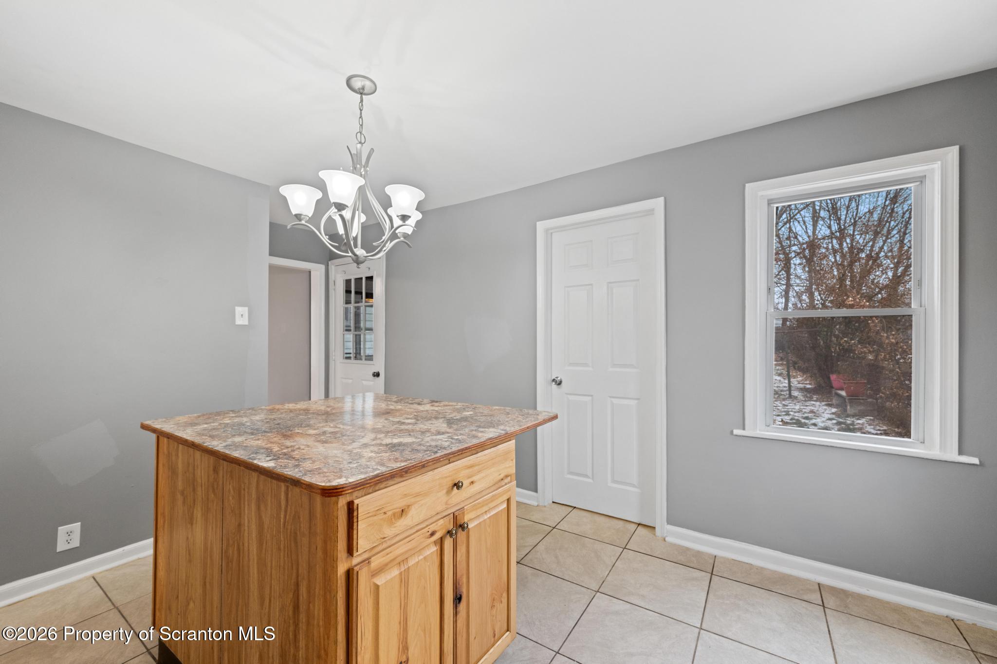 2717 North Main Avenue Scranton, PA 18508 - Photo 17 of 36 a room that has a table and a chandelier