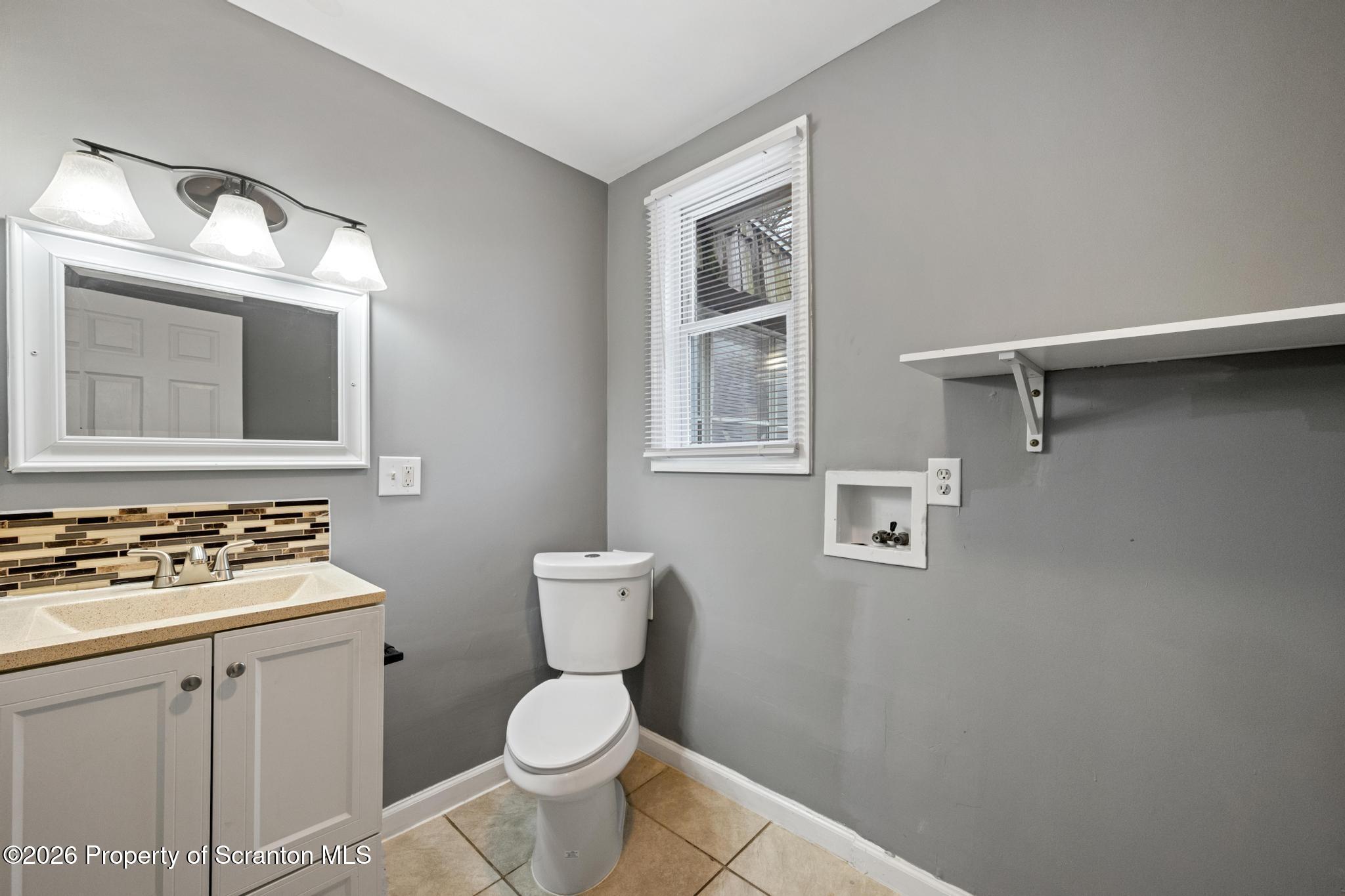 2717 North Main Avenue Scranton, PA 18508 - Photo 21 of 36 a white toilet sitting next to a bathroom sink