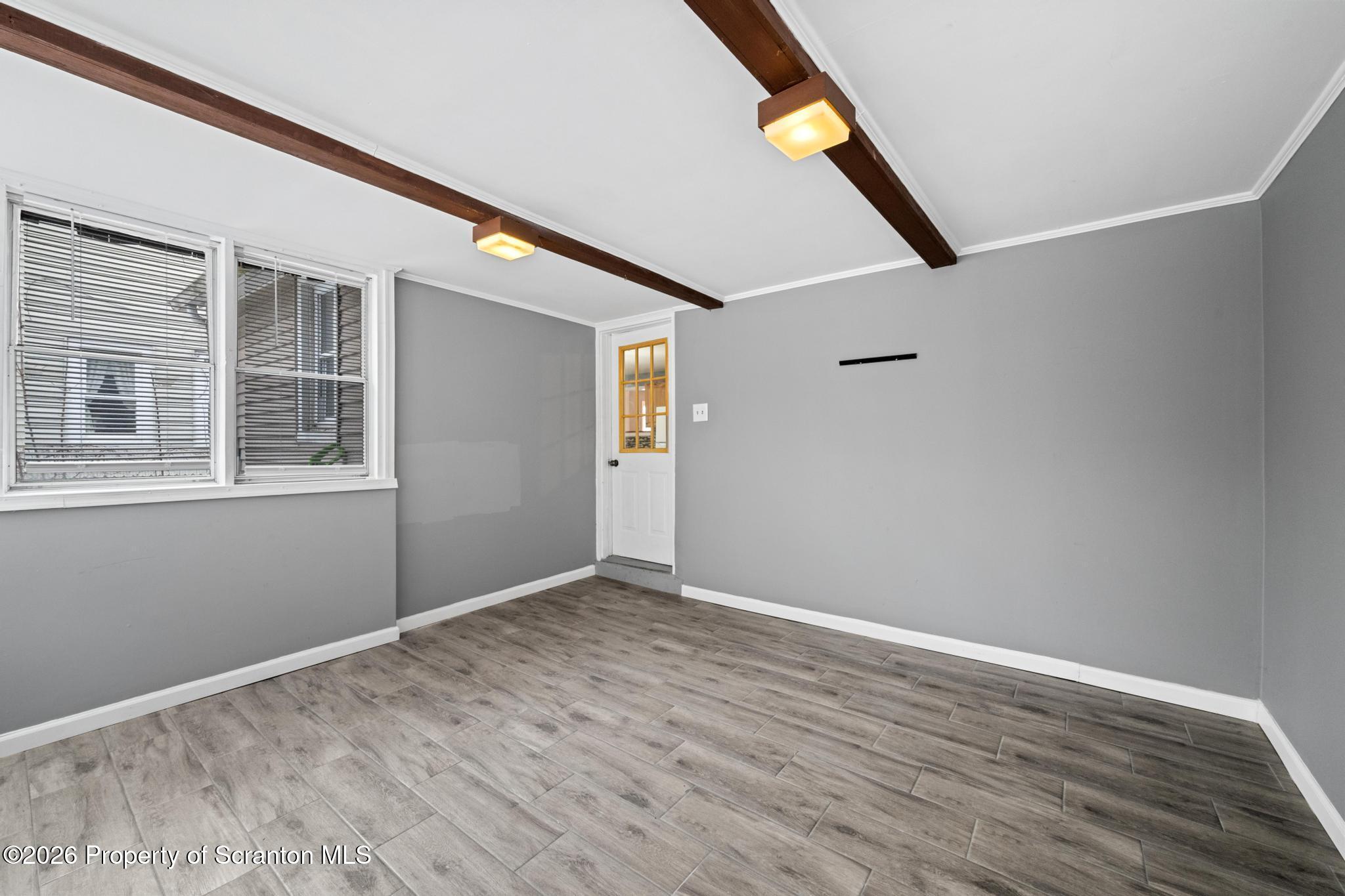 2717 North Main Avenue Scranton, PA 18508 - Photo 23 of 36 a view of an empty room with wooden floor and a window