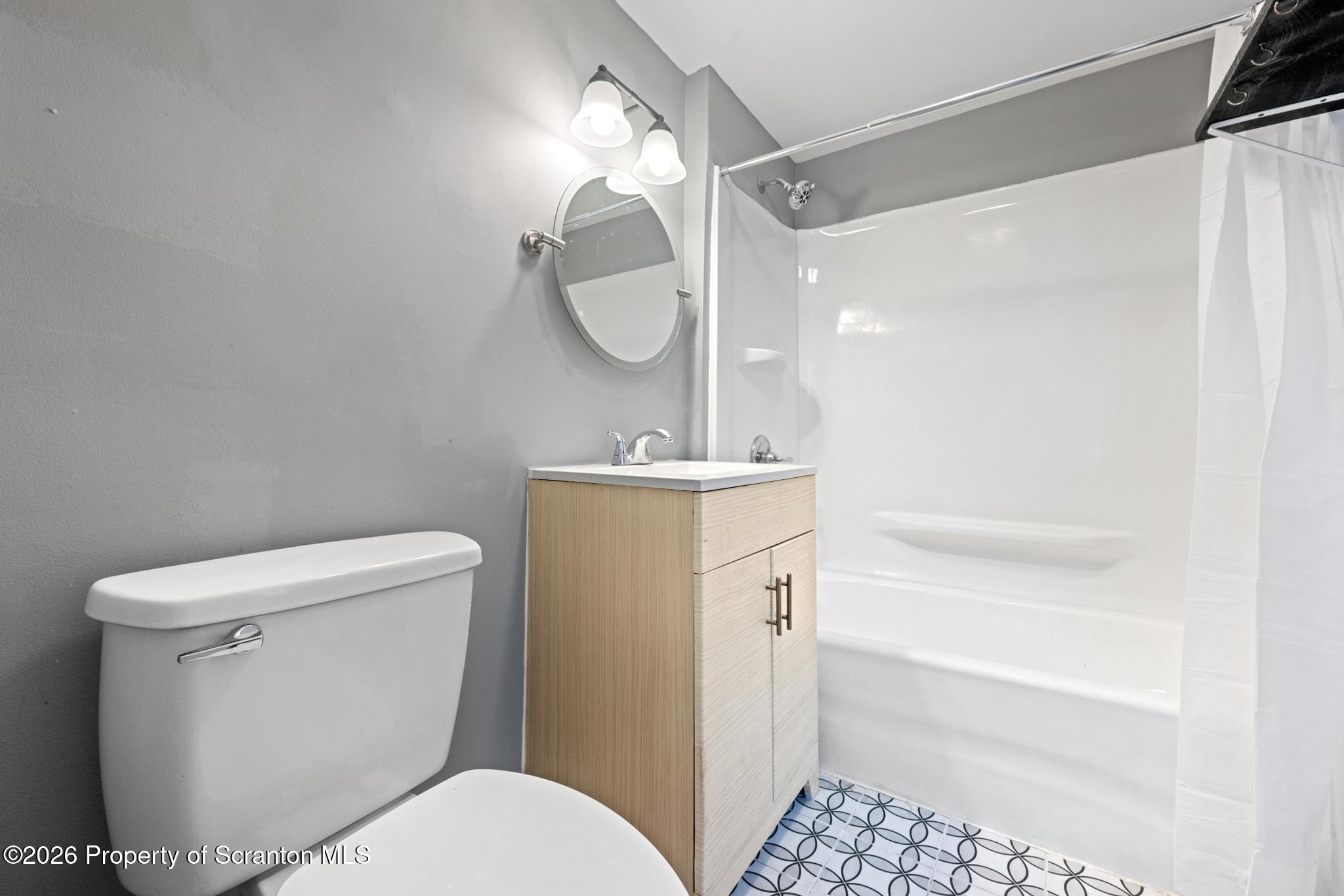2717 North Main Avenue Scranton, PA 18508 - Photo 34 of 36 a bathroom with a sink a toilet a mirror and shower